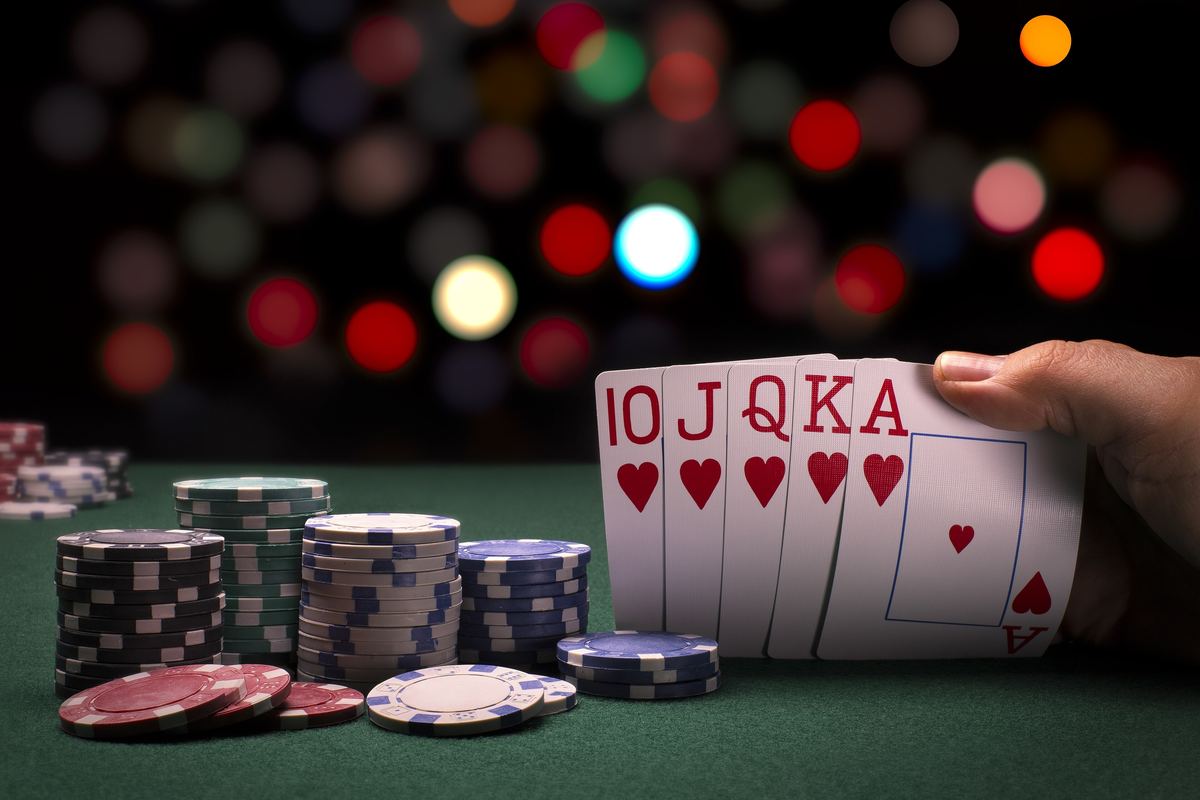 Royal flush and chips on a poker table